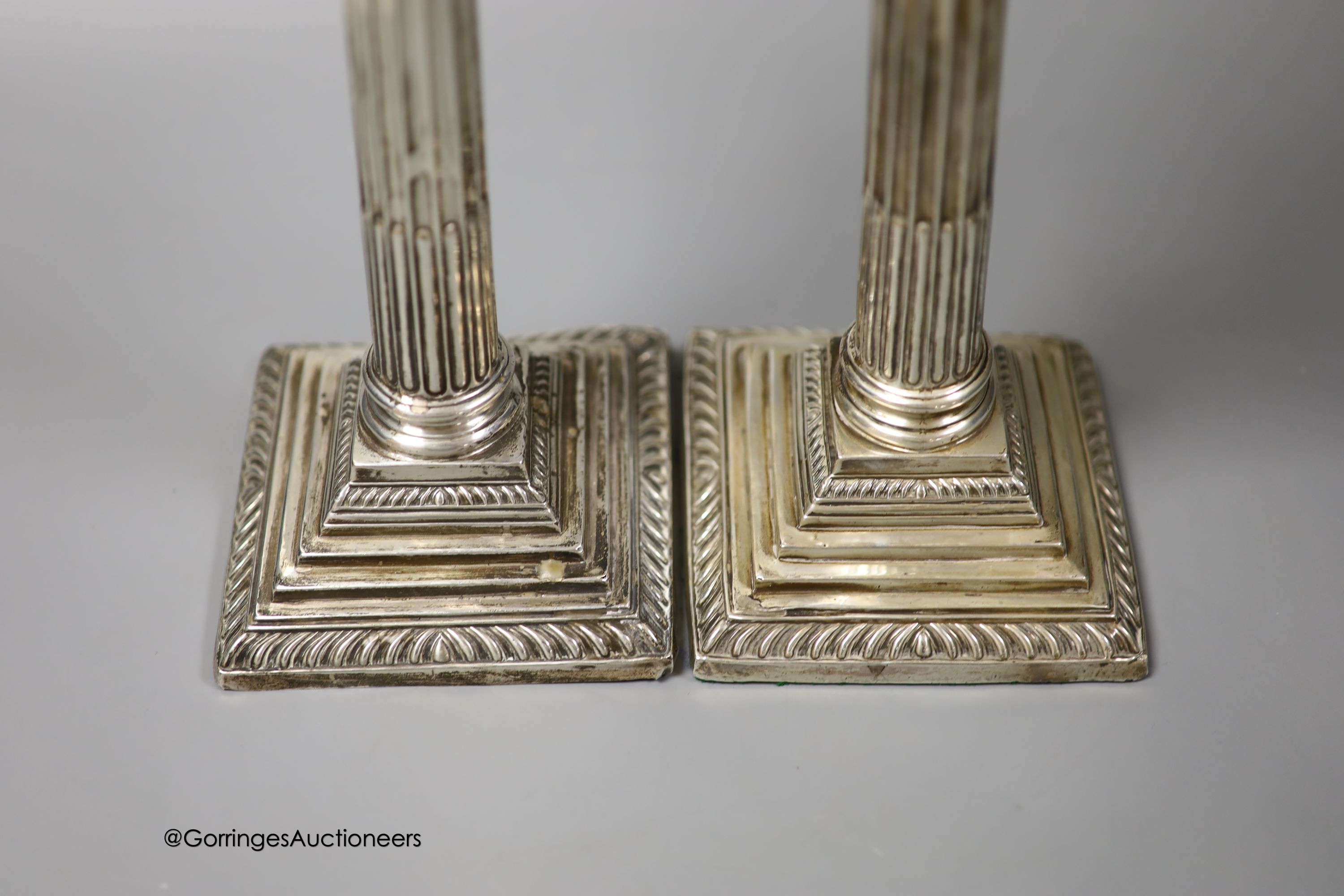 A pair of Edwardian silver corinthian column candlesticks, Walter Latham & Son, Sheffield, 1904, 24.5cm, weighted (a.f.).